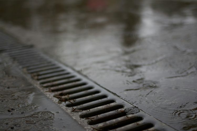 A slotted drain channel set in wet concrete