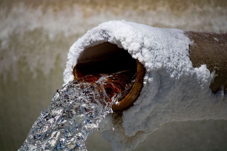 Water gushing out of a corroded pipe end