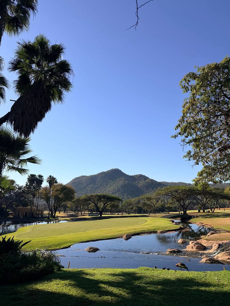Bushveld grass, a stream and hills in the Pilanesberg area north of Phokeng